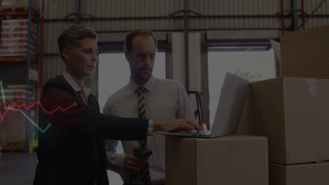 analyzing data on laptop, business professionals in warehouse working together