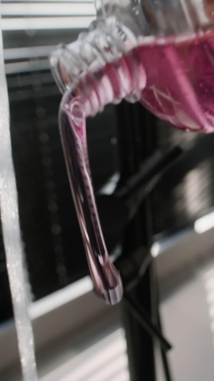 Pink Liquid Bottle and Foamy Water