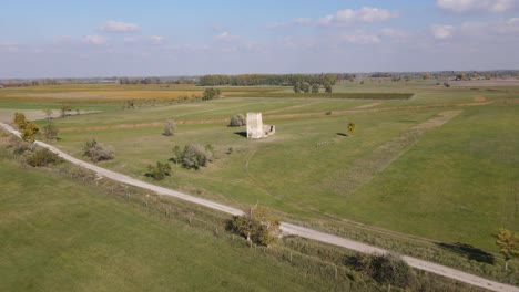 Wide-to-close-up-aerial-flying-towards-truncated-tower-Soltszentimre,-Hungary