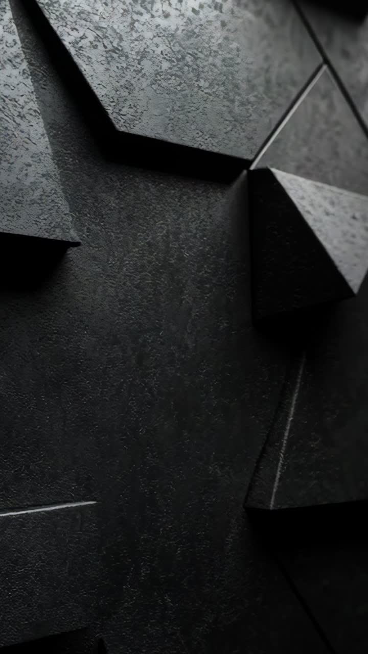 A black and white photo of a wall with many triangles. The photo is abstract and has a modern feel to it Vertical video