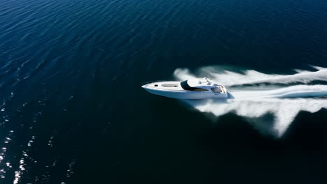 luxury yacht speeding across dark blue water leaving a large wake