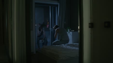 upset couple in bedroom at night