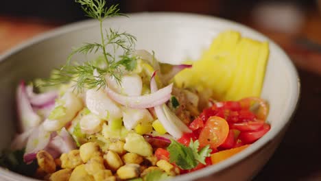 the complete dish of authentic traditional peruvian ceviche appetizer, perfectly mix of ingredients and beautifully garnished gourmet food, handheld slow motion shot