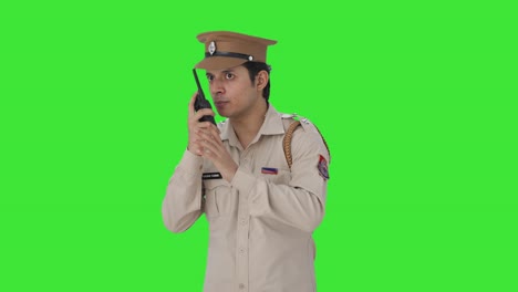 indian police officer giving instructions on walkie talkie green screen