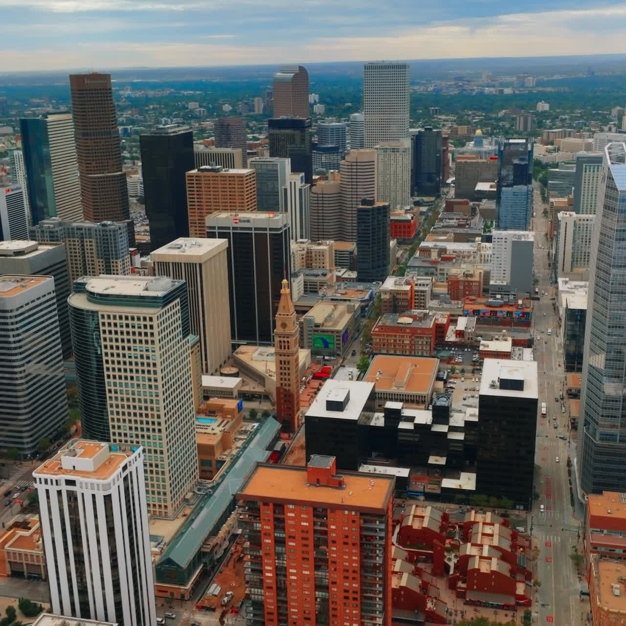 Contemporary downtown of Denver, Colorado, USA at cloudy daytime. Endless urban cityscape at backdrop of overcast sky. Top view
