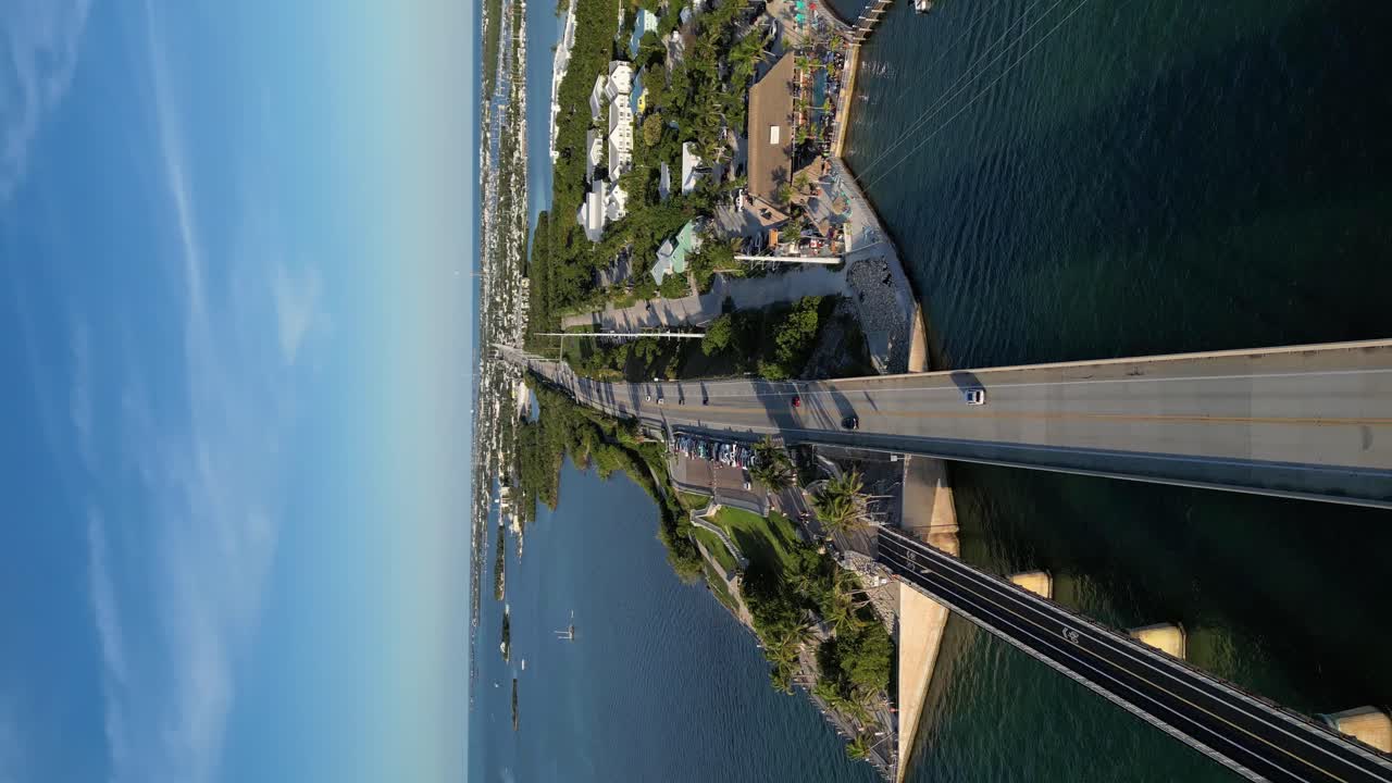 Drone shot of a car driving through the famous 7-mile bridge in the Florida Keys