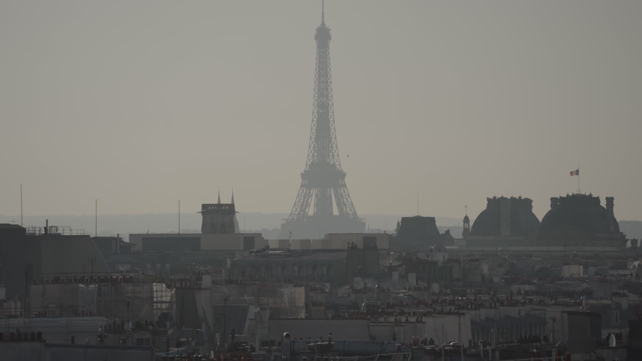 Eiffel Tower in Hazy Paris Cityscape