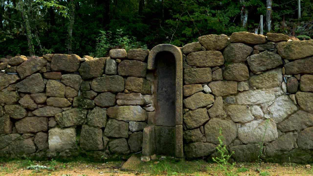 Ancient stone wall ruins in Castro Cibdá de Armeá archaeological complex, Ourense, Galicia