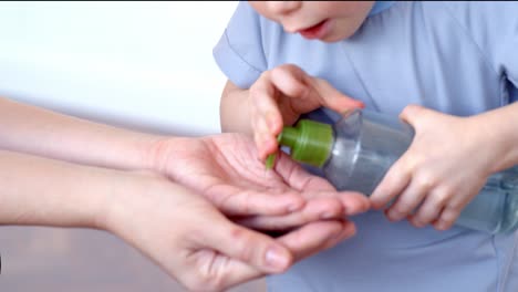 child learning hand sanitizer use