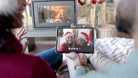 Two-happy-diverse-couples-having-christmas-tablet-video-call,-slow-motion