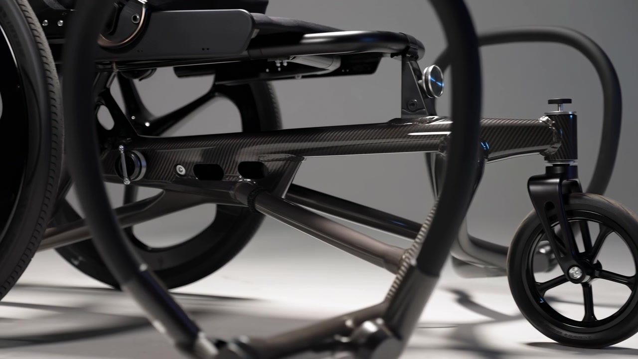 Low-angle close view of modern stroller front wheel and carbon fiber frame junction in studio lighting, with detailed wheel hardware, textured weave, glossy accents, and sleek premium design