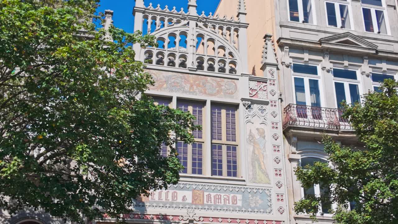 Tourists gather outside the famous Livraria Lello bookstore in Porto on a sunny day