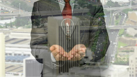 animation of light bulb over businessman hands and cityscape background