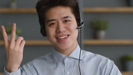 smiling asian man in a video call