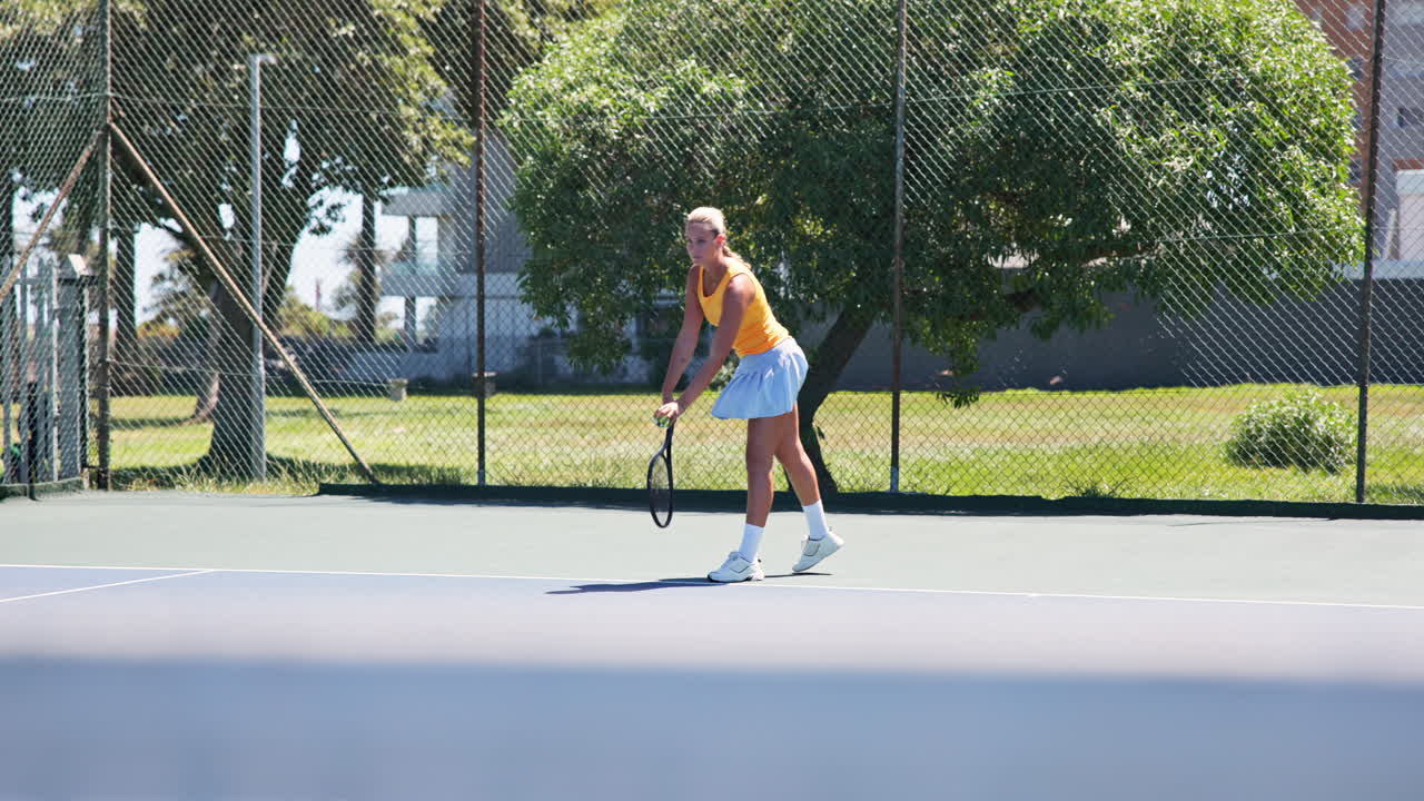 Athletic Woman and Man Playing Tennis on an Outdoor Court