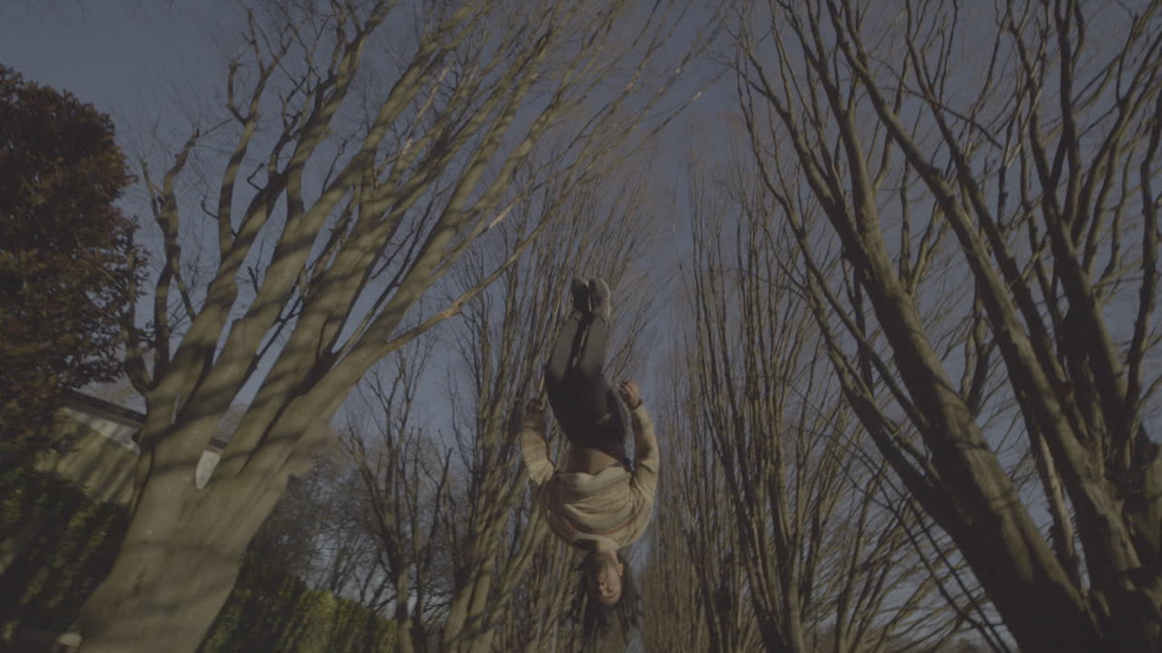 Parkour Backflip in a Tree Lined Park