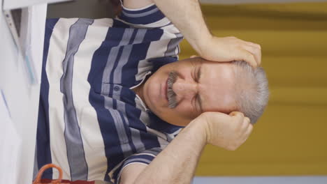 vertical video of home office worker old man having a nervous breakdown.