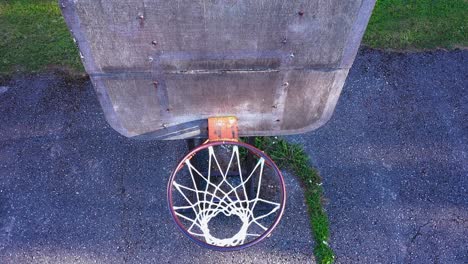 Basketball-hoop-in-close-up-top-down-view,-aerial-drone-fly