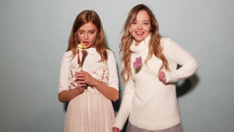 two girls having fun with party props
