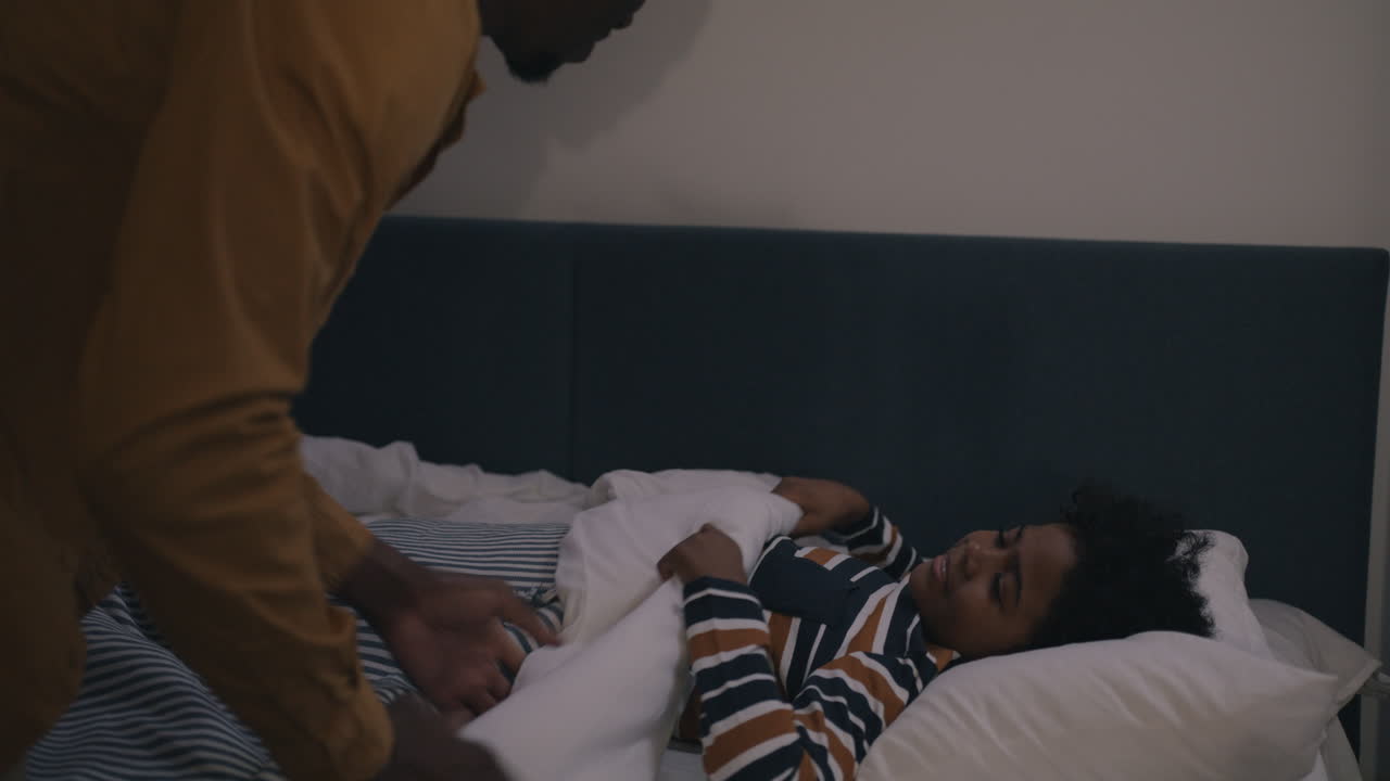 Father Putting Son to Bed