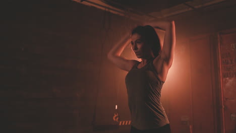 athletic young woman stretches her arms, back and shoulders before training