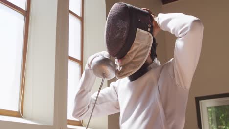 fencer athlete during a fencing training in a gym