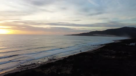 Spain-coastline-and-bright-sunset,-aerial-drone-view