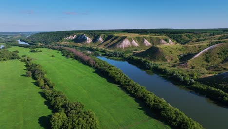 river landscape with lush green grasslands and hills