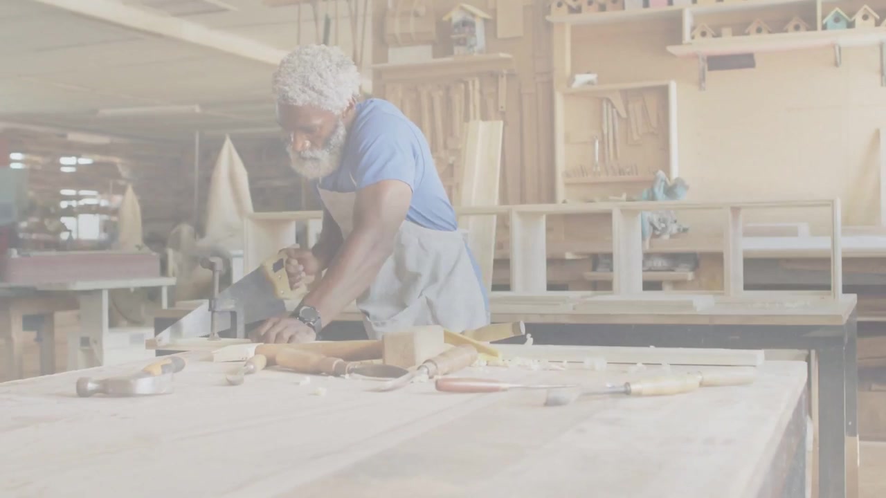 Senior carpenter inspecting wood, grabbing saw, cutting to size while animated guides guiding saw