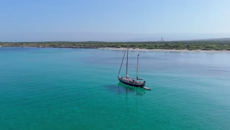 Sailboat-anchored-in-transparent-and-turquoise-sea-of-Cabo-Rojo-in-Dominican-Republic