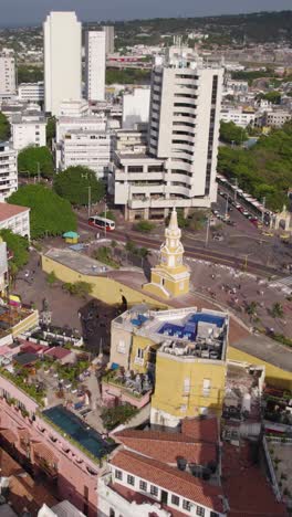 aerial view of the historic clock tower monument in cartagena, colombia, showcasing its colonial architecture amidst the modern cityscape. vertical video
