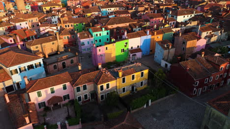 Flying Over Colorful Houses Of Burano Island At Sunset In Venice, Italy - Drone Shot