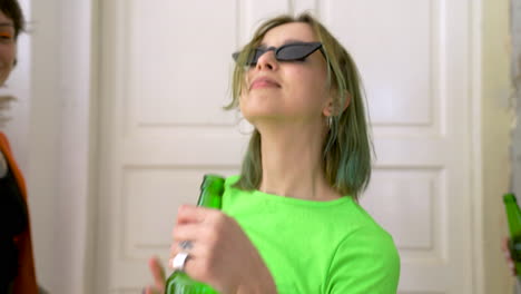 Group-Of-Four-Happy-Girl-Friends-Holding-Beer-And-Dancing-During-A-Party-At-Home-2