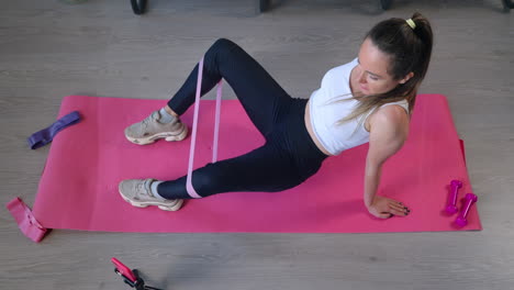 woman doing resistance band leg exercises at home