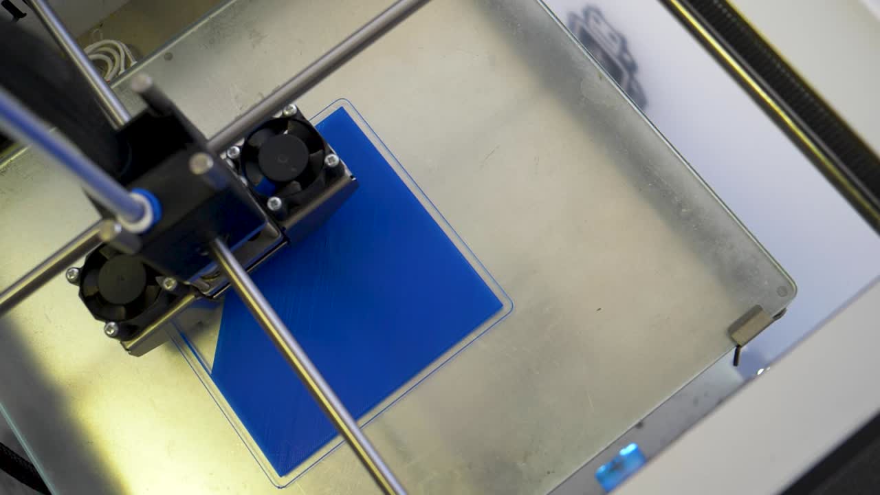 Close Up of a 3D Printer printing with blue Material