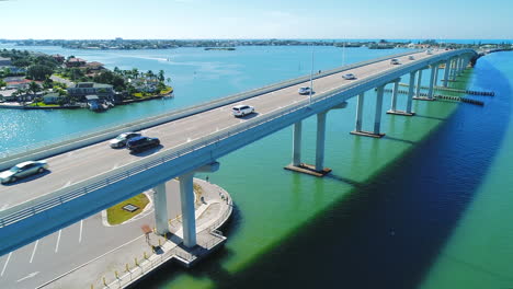 Drone-flying-along-traffic-on-the-Belleair-Bridge-heading-to-Clearwater-Beach,-FL