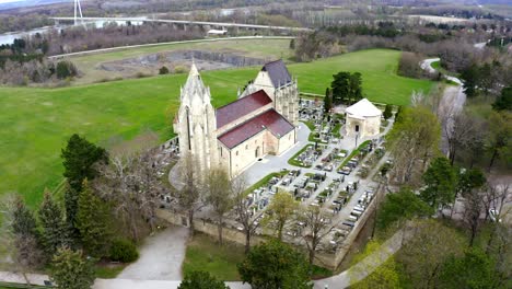 panorama of historical romanesque church and cemetery in bad deutsch-altenburg, austria