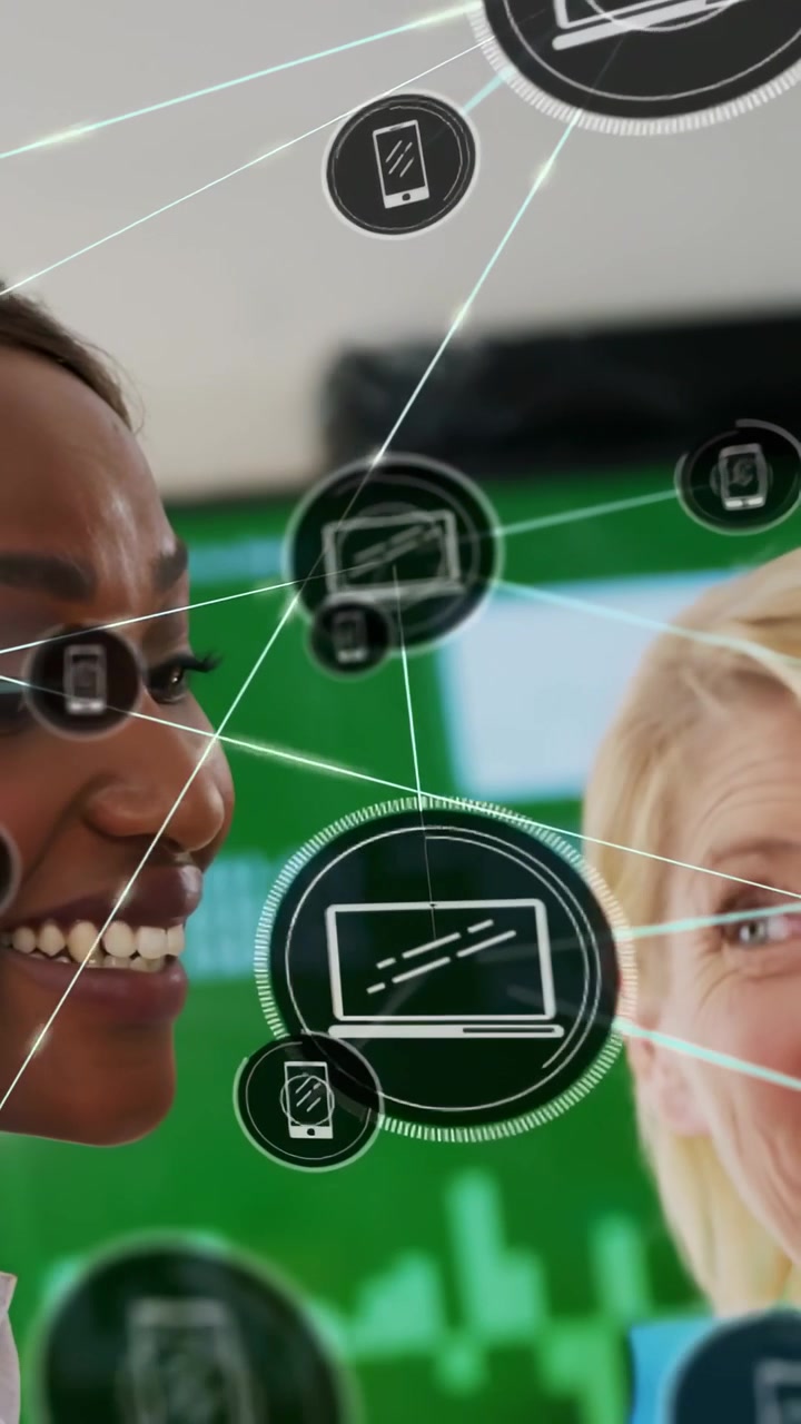 Vertical video: Two tech pros holding blue folder demoing phone and laptop icons overlaying faces