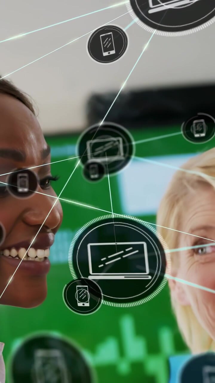 Vertical video: Two tech pros holding blue folder demoing phone and laptop icons overlaying faces