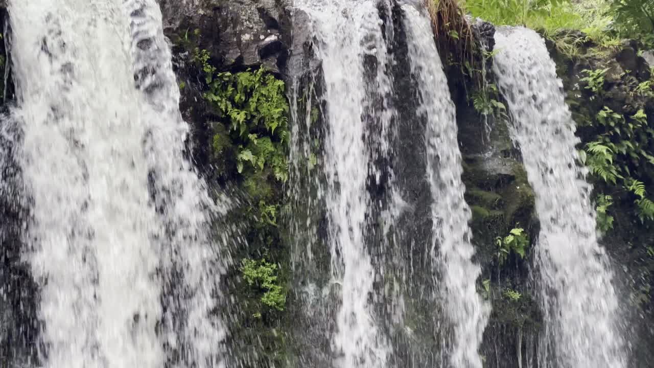 Cinematic close-up booming up shot of Upper Waikani Falls along the Road to Hana in Maui, Hawai'i