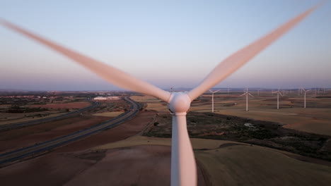 wind farm at sunrise/sunset with highway