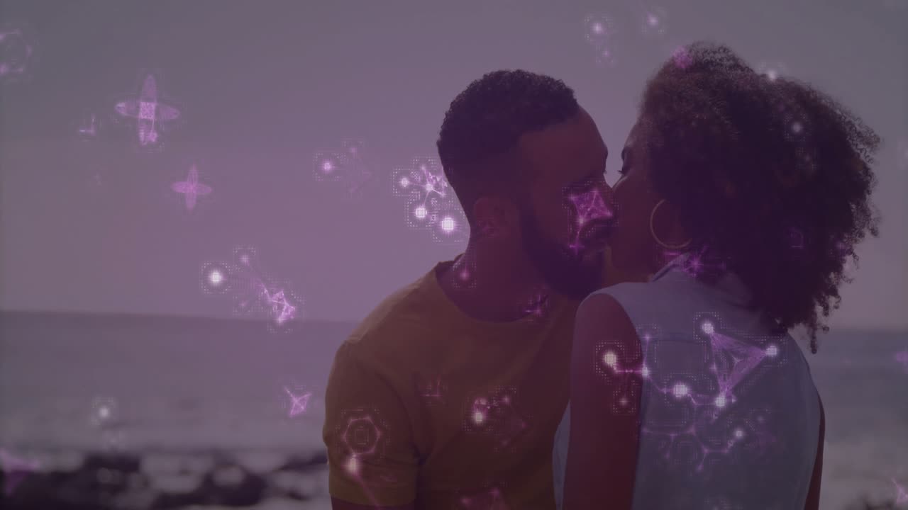 Man cupping woman's face and initiating kiss on shore using AR tech with drifting purple molecules