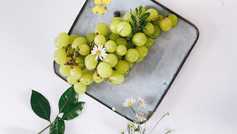 fresh green grapes on a plate with flowers