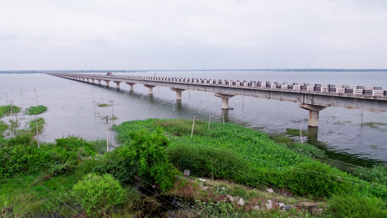 Current pole's under krishna river with trees and Korthi Kolhara Bridge at karnataka, india. day time, push in shot, drone shot, 4k