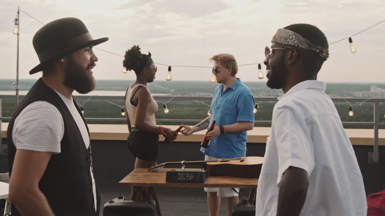 Guys Greeting Each Other at Rooftop Party
