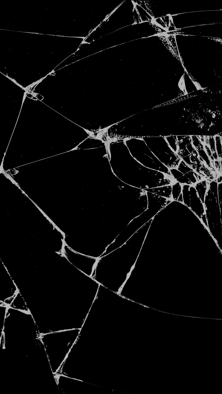 A complex, detailed pattern of cracks on shattered glass. A static vertical overlay for themes of severe damage, accidents, or destruction