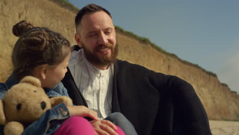 Happy-dad-child-smiling-on-seaside-beach.-Lovely-family-relax-together-outdoors.