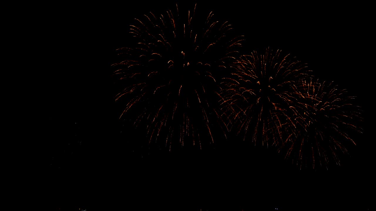 4K. seamless loop of real golden fireworks festival in the sky display at night during national holiday, new year party or celebration event