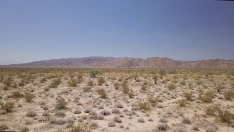 drone-flying-low-over-desert-landscape