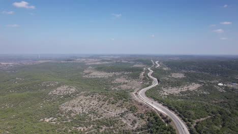 high angle aerial view of the devil's backbone on fm32, cars driving in the texas hill country